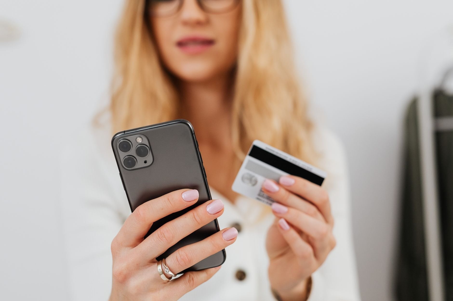 Woman using a smartphone and credit card for online shopping