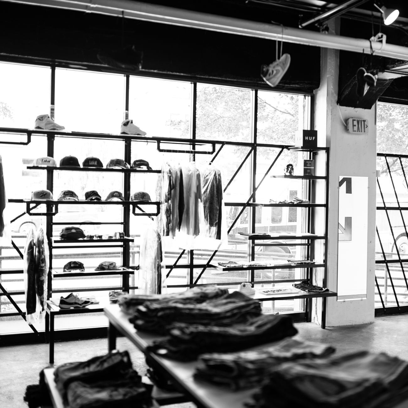 Retail clothing store interior with hats, shirts, and racks
